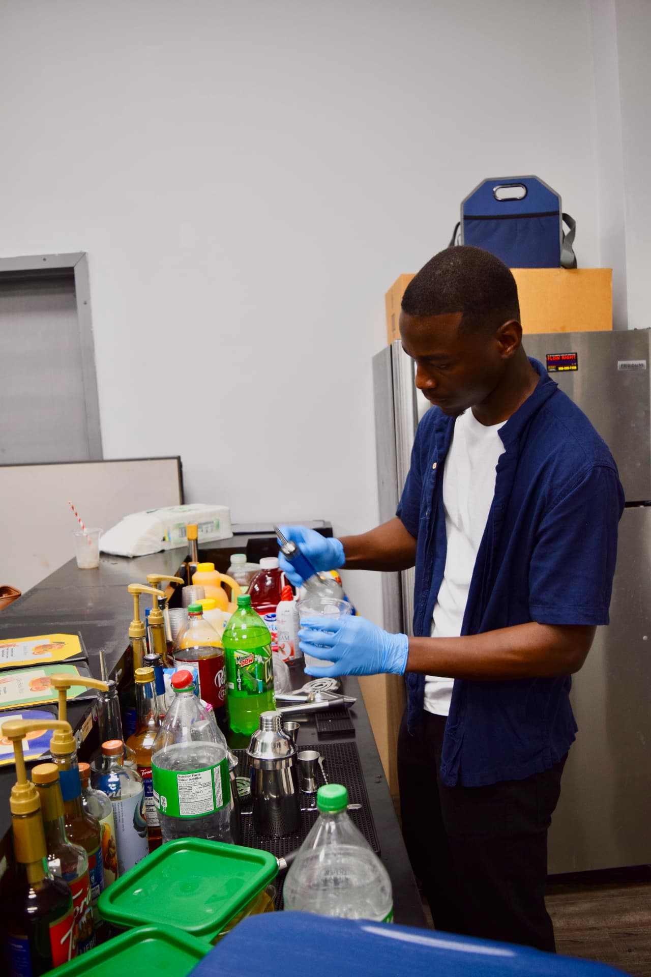 Bartender preparing a drink behind the Nektar bar station